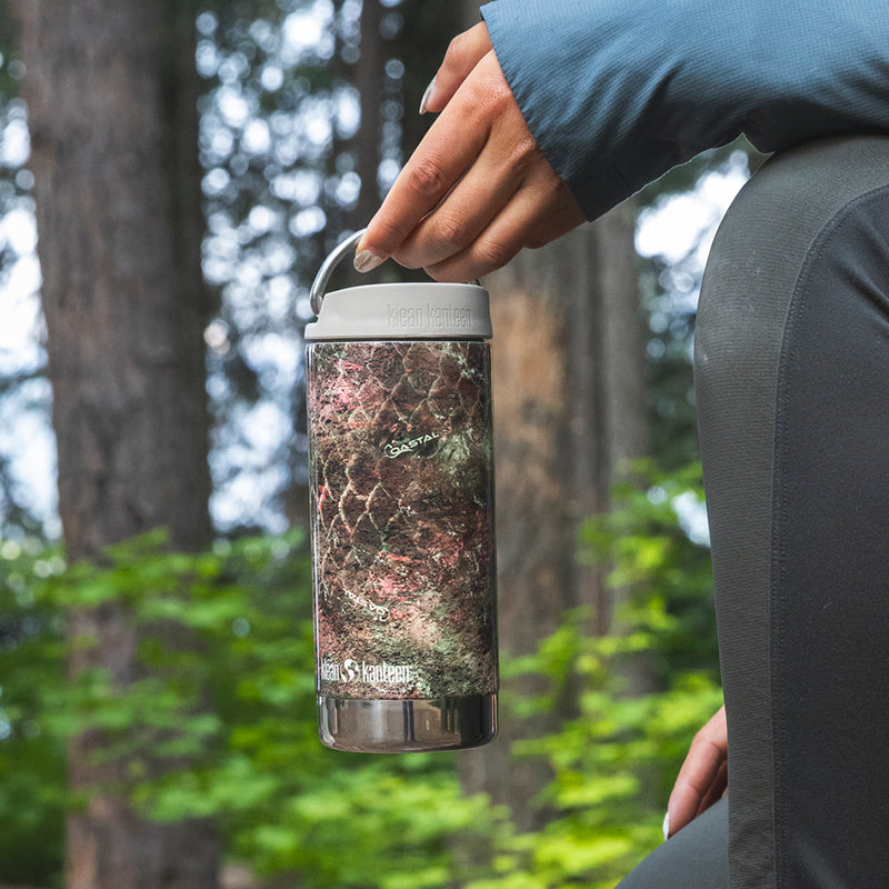 12oz-tkwide-with-cafe-cap-mossy-oak-z1 12oz_tumbler_mossyoak_rainbowtrout_hand_closeup_square.jpg