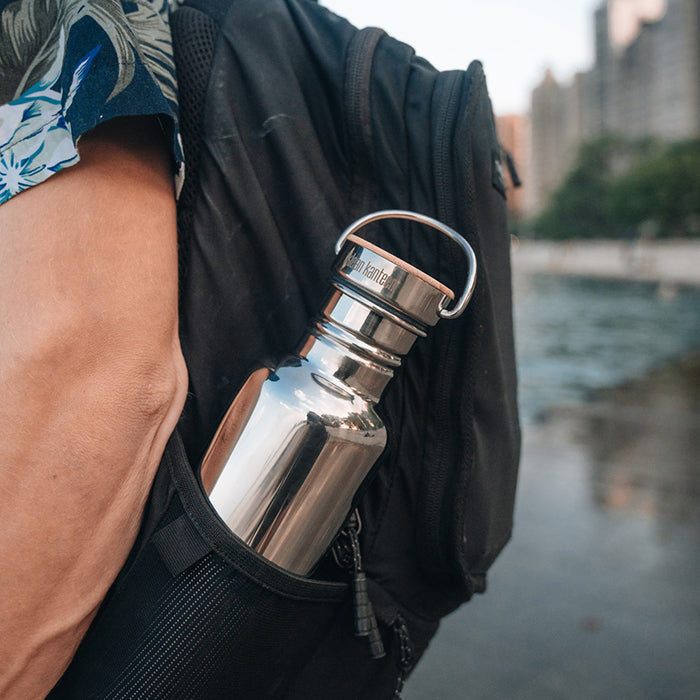 27oz-reflect-with-bamboo-cap-e1 K27SSLRF-MS-BAMBOO_reflect-bottle_backpack_lifestyle.jpg